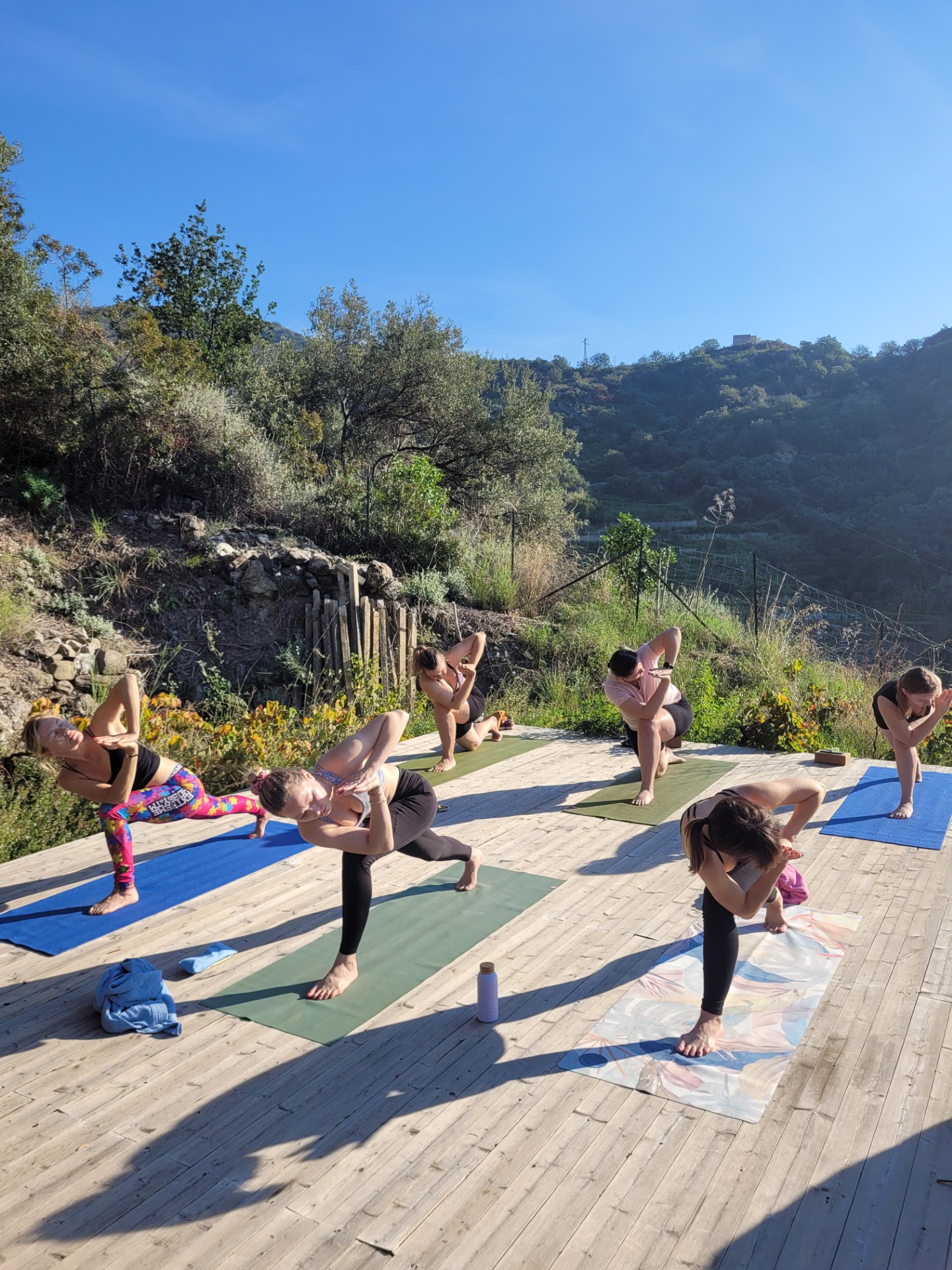 group doing yoga on a hill